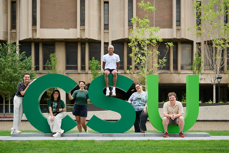 Students on big CSU letters on campus