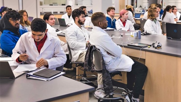 Students listening to a lecture in a lab