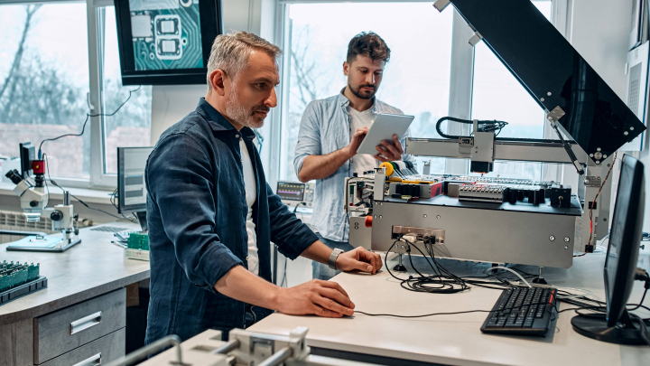 Illustrating two men working in a microelectronics lab.