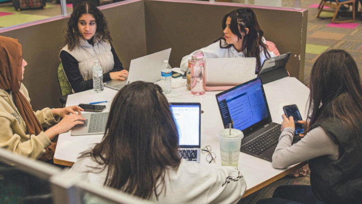 A group of people sitting with computers