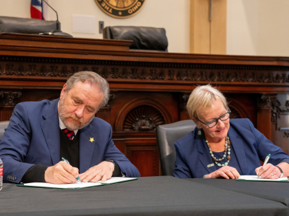 Attorney General Dave Yost and CSU President Laura Bloomberg signing MOU