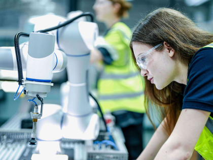 Woman operating smart technology in a manufacturing setting