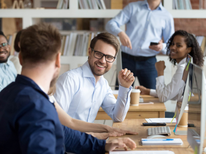 group of colleagues sitting around a table